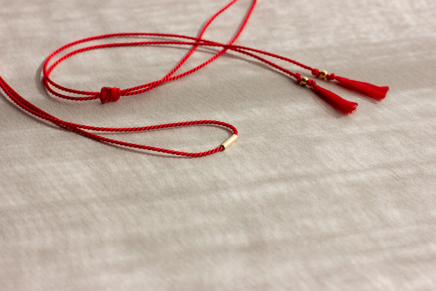 Light red string necklace with tassels and silver beads