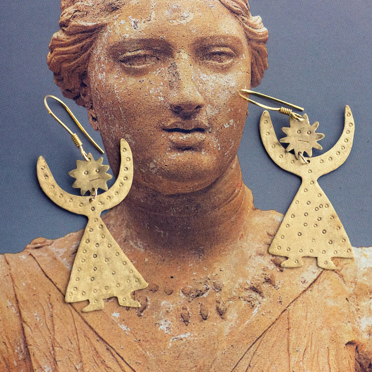 A pair of brass crescent moon and star dangle earrings 