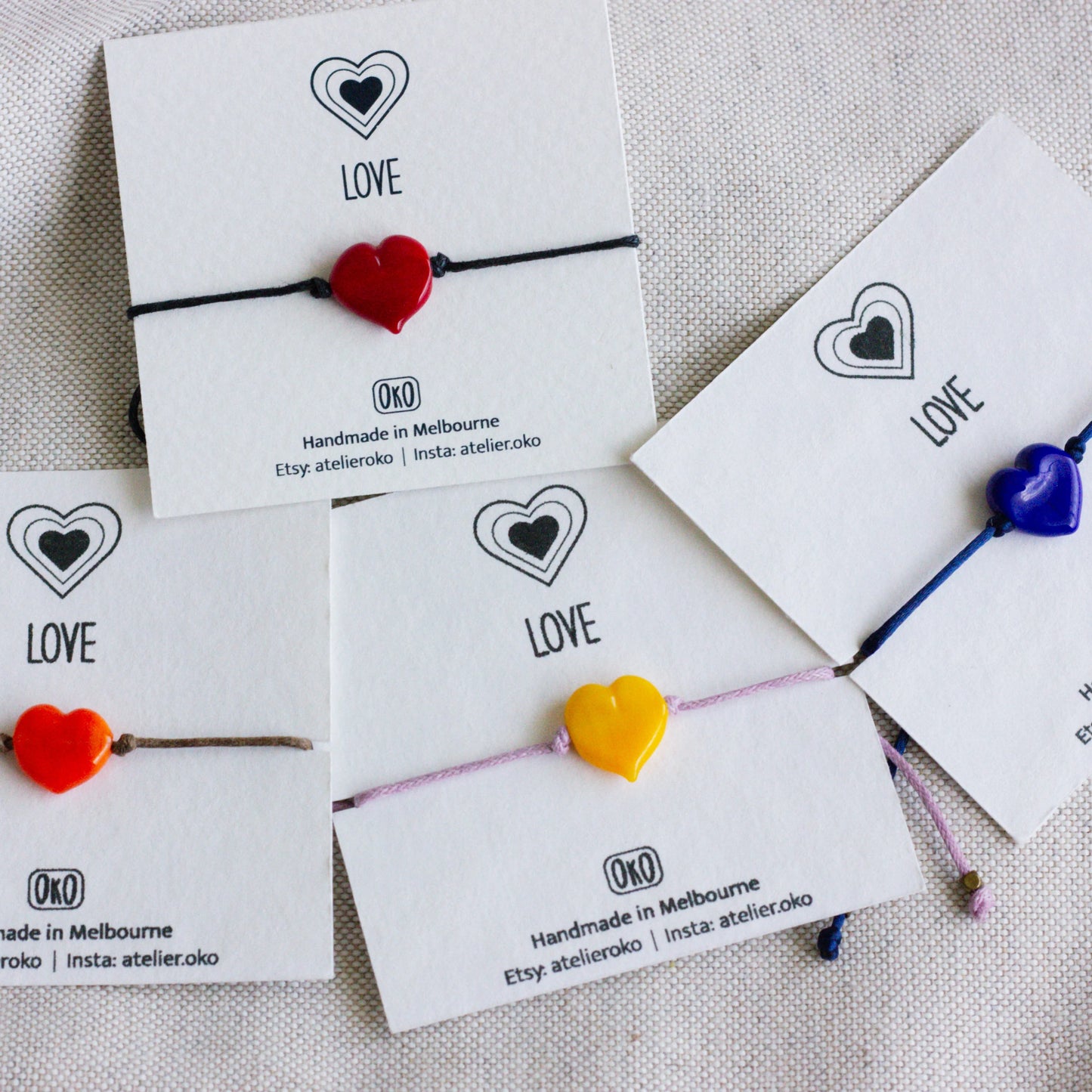 Heart-shaped bracelets on cards with 'LOVE' 
