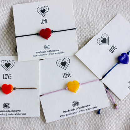 Heart-shaped bracelets on cards with 'LOVE' 