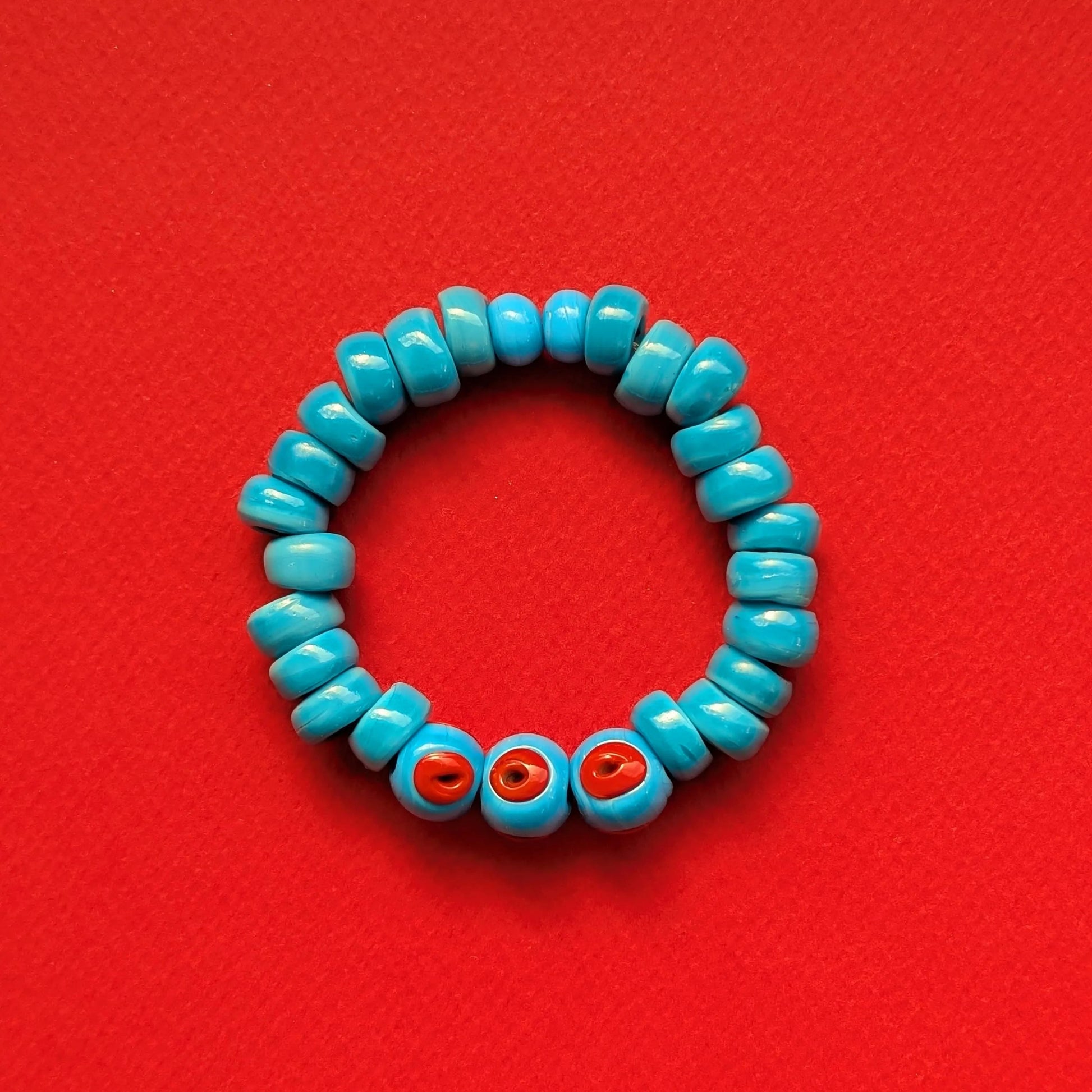 Turquoise beaded bracelet with red accents