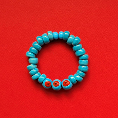 Turquoise beaded bracelet with red accents